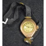 A vintage lady's 9ct gold wristwatch, oval case, round silvered dial, Arabic numerals, minute track,