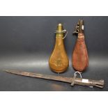 A bayonet; brass and copper powder flask;