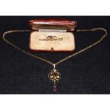 An Edwardian 9ct gold pendant, yellow metal fancy link chain, 5.4g gross; a 9ct gold brooch, 1.