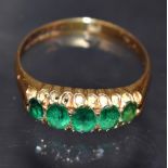 An Edwardian emerald five stone ring, five graduated mid green emeralds, 18ct gold shank,