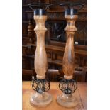 A pair of iron and turned wooden table candlesticks