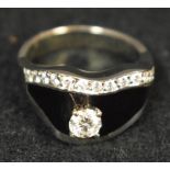 A diamond and black enamel Pirates Hat crest ring, raised claw diamond approx 0.