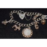 A silver curb link charm bracelet, love heart clasp,