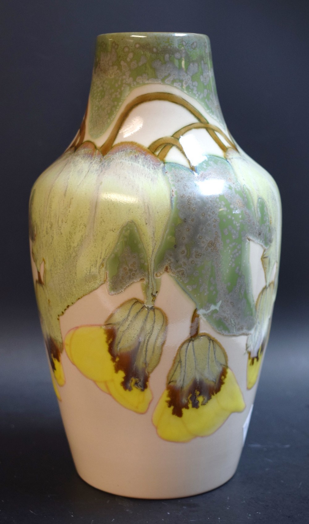 A Cobridge stoneware shouldered baluster vase, applied with large leaves and petals,