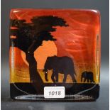 A large Caithness rectangular paperweight, Elephants, in silhouette on a red and orange ground, 16.