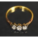 A diamond trilogy ring, three round old brilliant cut diamonds, platinum crown, 18ct gold shank,