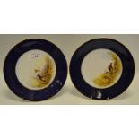 A pair of Royal Worcester plates, painted to centre with Mallards in Flight and Pheasant, signed C.