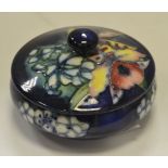 A Moorcroft powder bowl and cover, Orchid on a blue ground ,
