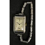 Omega - an Art Deco steel cased wrist watch, rectangular silvered dial, Arabic numerals,