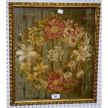 An early 19th century needlework, wreath of flowers, with monogram, EW, for Elizabeth Wellberry,