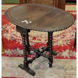 A Victorian oak bobbin turned drop leaf table.