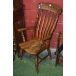 An elm lath back Windsor style chair, outswept arms, saddle seat,