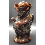 A treacle glazed Snuff Taker character jug, 25cm in height,