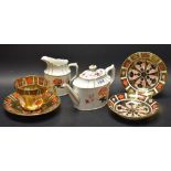 A pair of Royal Crown Derby 1128 Imari saucers; a Royal Crown Derby Bali teapot and cream jug,