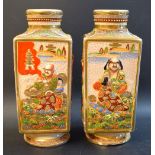 A pair of Japanese Satsuma panelled vases, moulded in relief picked out in gilt and polychrome,