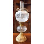 A late Victorian oil lamp, cast brass base,