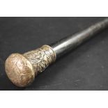 A Chinese silver mounted gentleman's walking cane, pommel embossed with figures, ebony shaft,