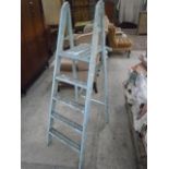 pair of painted wooden step ladders