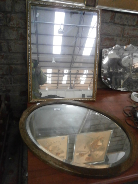 oval wood framed bevel edge mirror and 1 other