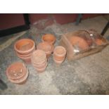 selection of terracotta plant pots and a garden basket
