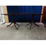 Twin Mahogany Pedestal dining table with one leaf, pedestals with brass capped castors, late 19th