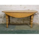 Oval Pine wake type table with hinged drop flaps.