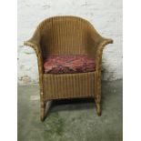 Lloyd Loom armchair in gold colour finish.