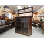 Glazed Bookcase Cabinet with upper tier on brass X frame supports early 19th century. ~