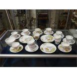 A collection of vintage cup and saucers with delightful paintings depicting flowers and country