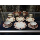 A collection of decorative tea set items including Japanese tea pot, milk jug and cup and saucer.