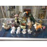 A selection of animal figurines in wood, china and metal mainly birds and dogs including a Peter