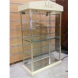 Glass display cabinet labelled 'Jules'. Lead to be cut before leaving saleroom