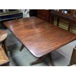 Twin Mahogany Pedestal dining table with one leaf, pedestals with brass capped castors, late 19th