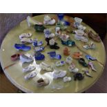 A collection of 43 miniature china, terracotta and delft shoes and boots, including ....