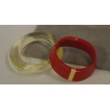 Two modern bangles including a red Art Deco style marked 'Monet'