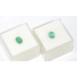 Two unset lime green Columbian emeralds