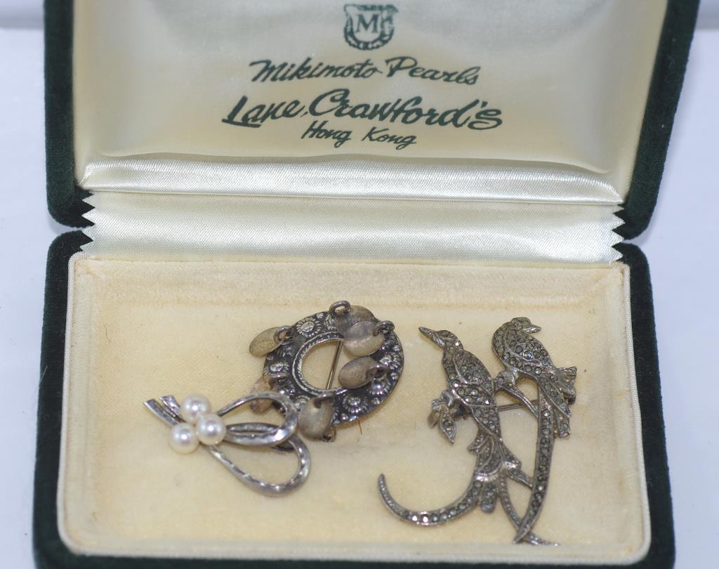 Mikimoto pearl brooch in box together with a marcasite bird brooch and a silver 850 brooch