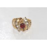 Vintage fancy gold and garnet ring marked 18ct, with 2 colourless gems to each shoulder, weight: