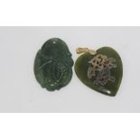 Carved green stone peach pendant with another green stone pendant