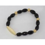 Onyx and carved ivory (1930s) stretch bracelet