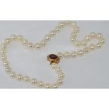 Good string of cultured pearls with 14ct gold & garnet clasp, 45 pearls, approx 9-9.95mm, weight: