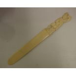 Antique carved ivory page turner with decorative figural handle, 36.5 cm long