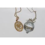 Two vintage medallions on metal chains including 14ct gold pendant for H.C. Johnson (approx 4gms)