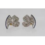 Good platinum, diamond and sapphire earrings in Art Deco style in a fluted fold-over bow with 24