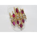 14ct gold, ruby and diamond dress ring including 7 marquis cut rubies and 8 round brilliant cut