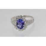 14ct white gold, tanzanite (2.5ct) & diamond ring incorporating diamonds TDW= approx 1ct in a claw