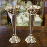 Pair of sterling silver vases hallmarked Birmingham 1919, loaded bases, 20cm high approx.