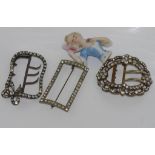 Three vintage buckles & a half doll