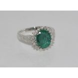 18ct white gold, emerald (1.29ct) and diamond ring total diamonds = 0.69ct, weight: approx 4.4