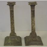 Pair of silver plate candlesticks in column form decorated in relief with urns and leaves, H32.5cm